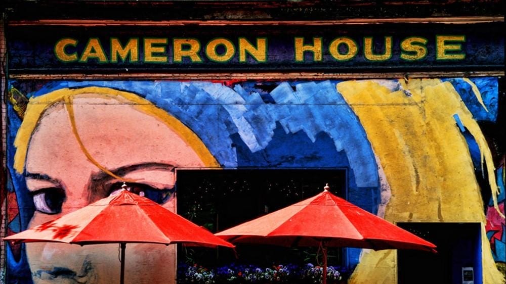 Painted exterior mural and patio umbrellas at The Cameron House Local bands in two small Queen West rooms