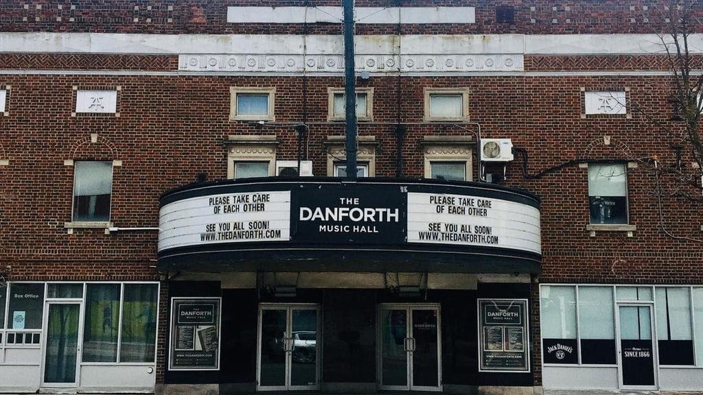 Brick facade and marquee of The Danforth Music Hall Touring bands and comedy beside Broadview Station